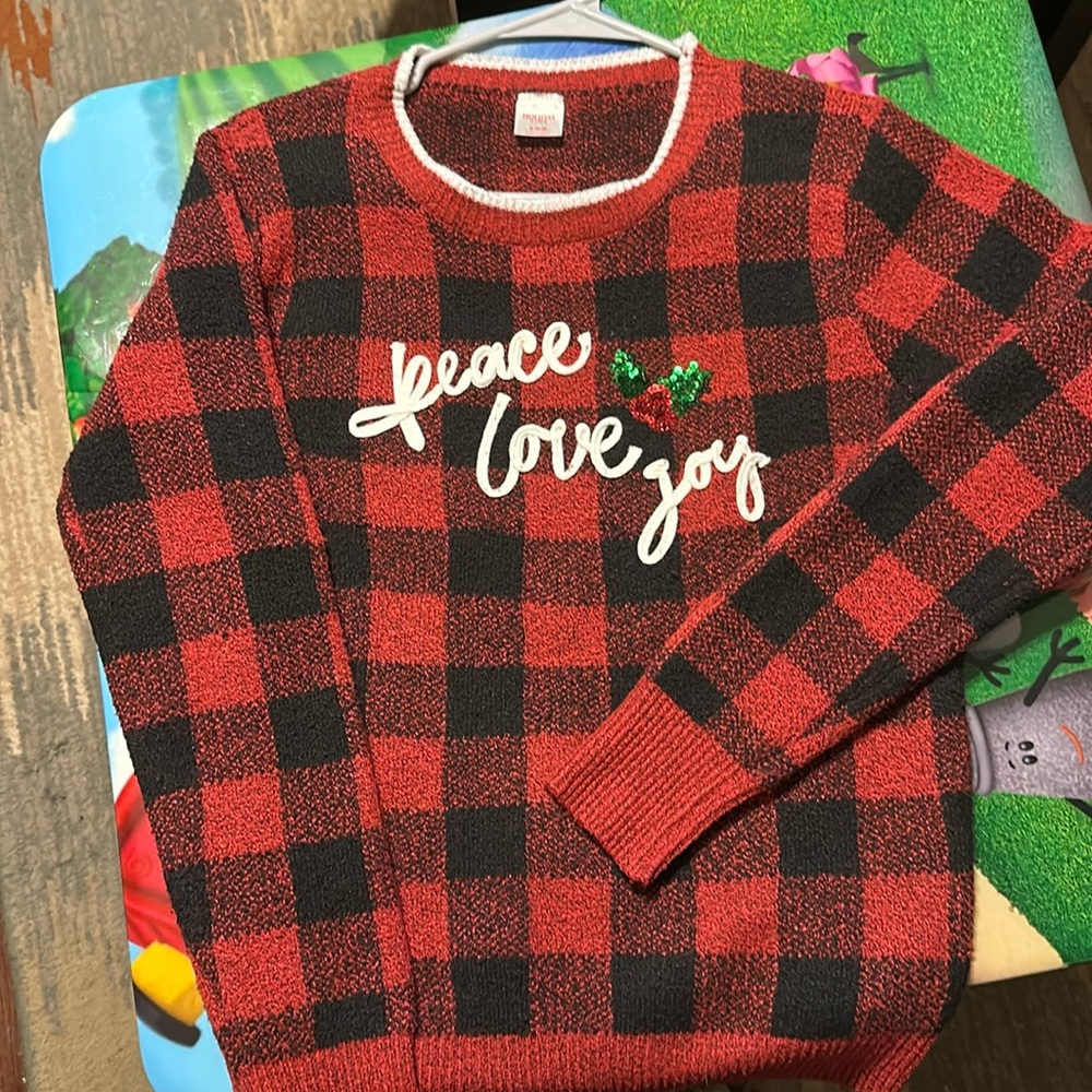 Woman’s Christmas sweater size  (4-6). 
Polyester/spandex